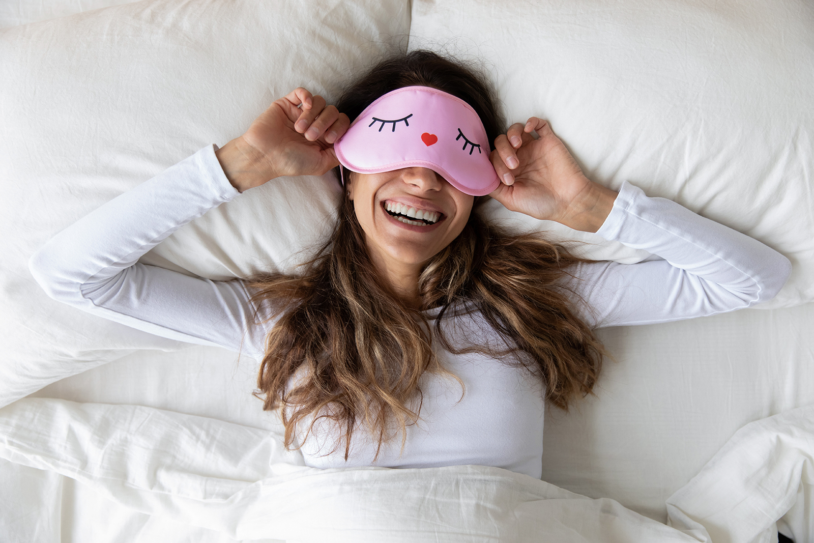 Cannabis vs. Alcohol for Sleep - Smiling Woman in Bed with Eye Mask